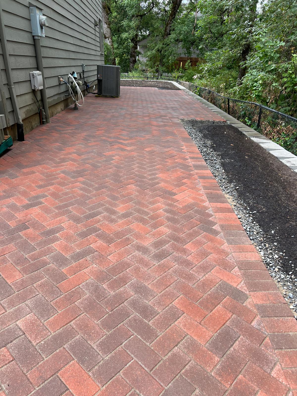 Red brick paver walkway completed by Metro Mowing Services and Maintenance LLC