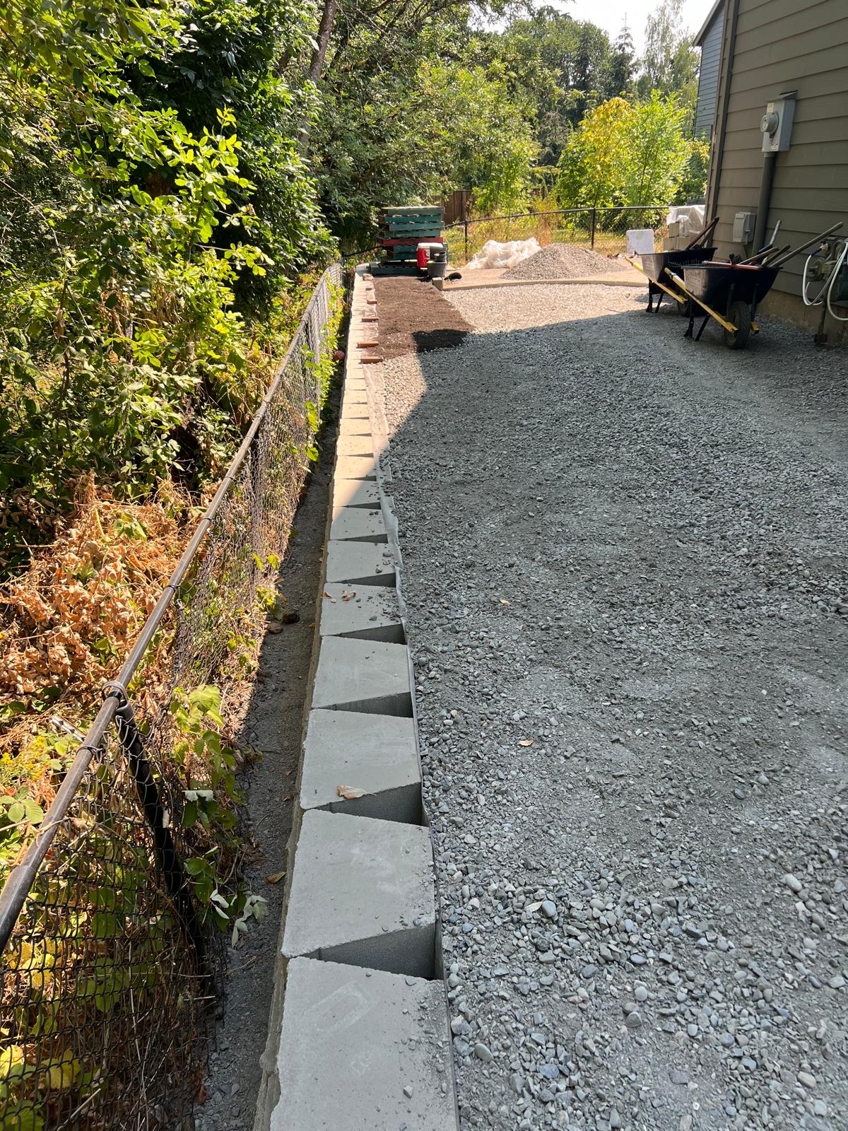 Gravel side yard with block edging completed by Metro Mowing Services and Maintenance LLC