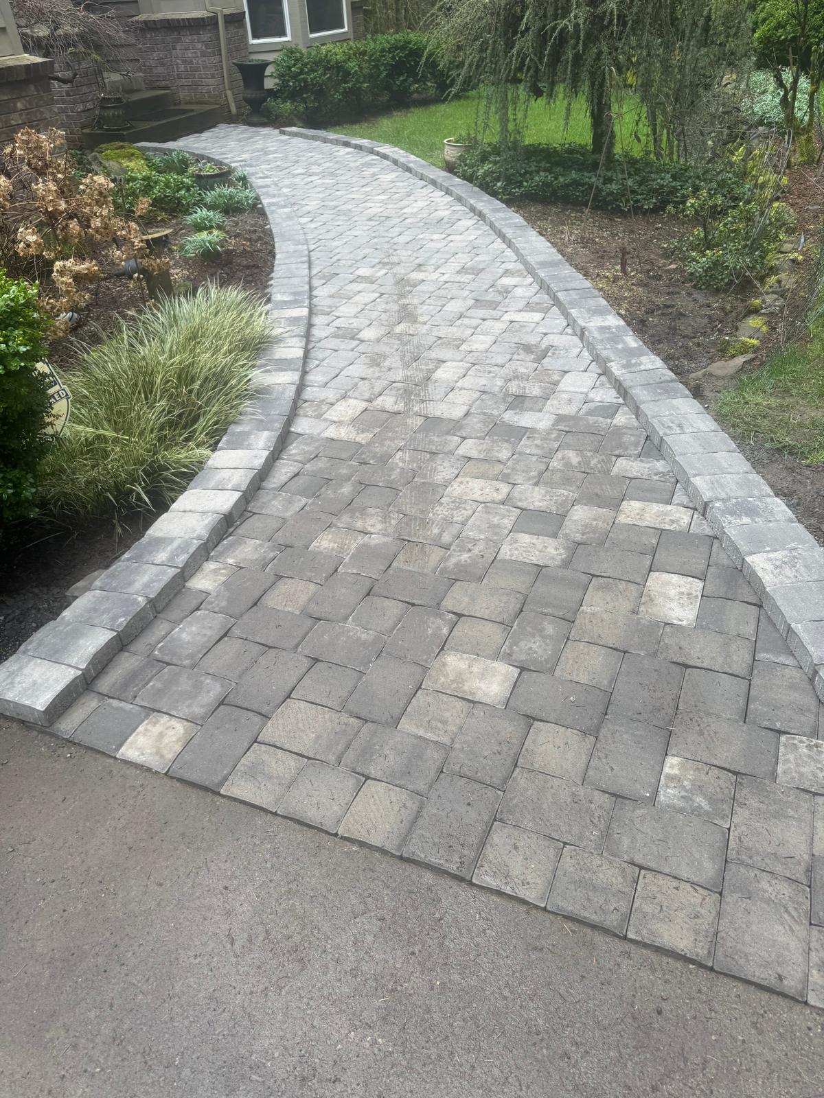Curved paver walkway completed by Metro Mowing Services and Maintenance LLC