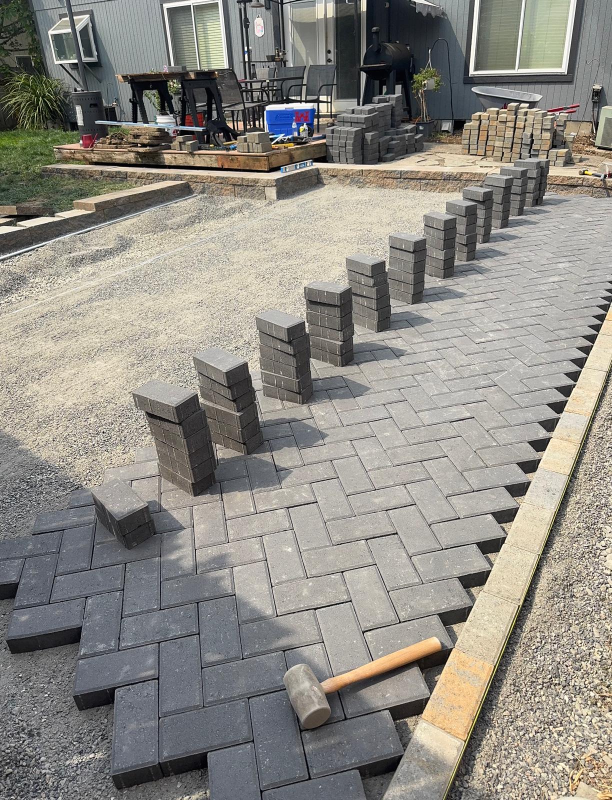 Paver patio install with edge restraint completed by Metro Mowing Services and Maintenance LLC