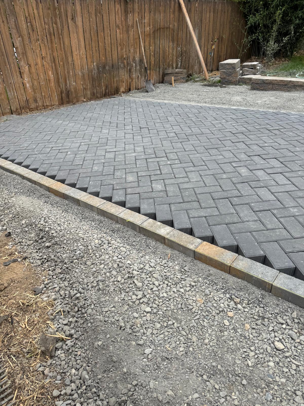 Paver patio over compacted gravel base completed by Metro Mowing Services and Maintenance LLC