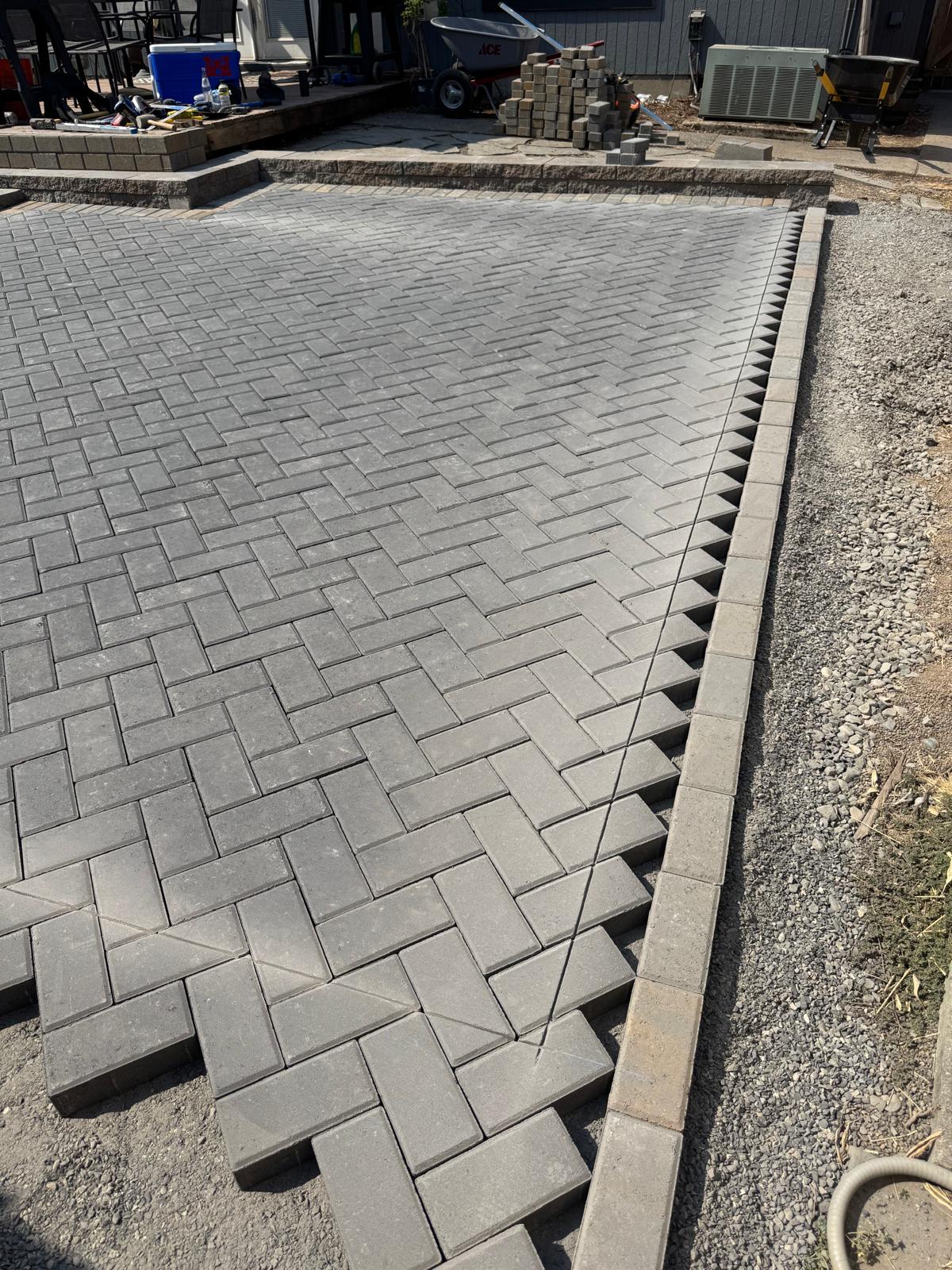 Paver patio edge detail completed by Metro Mowing Services and Maintenance LLC
