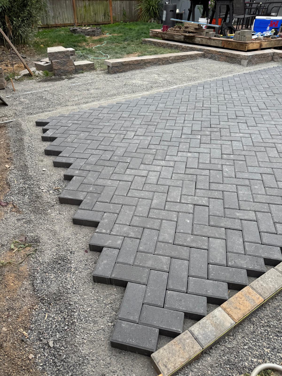 Gray herringbone paver patio completed by Metro Mowing Services and Maintenance LLC