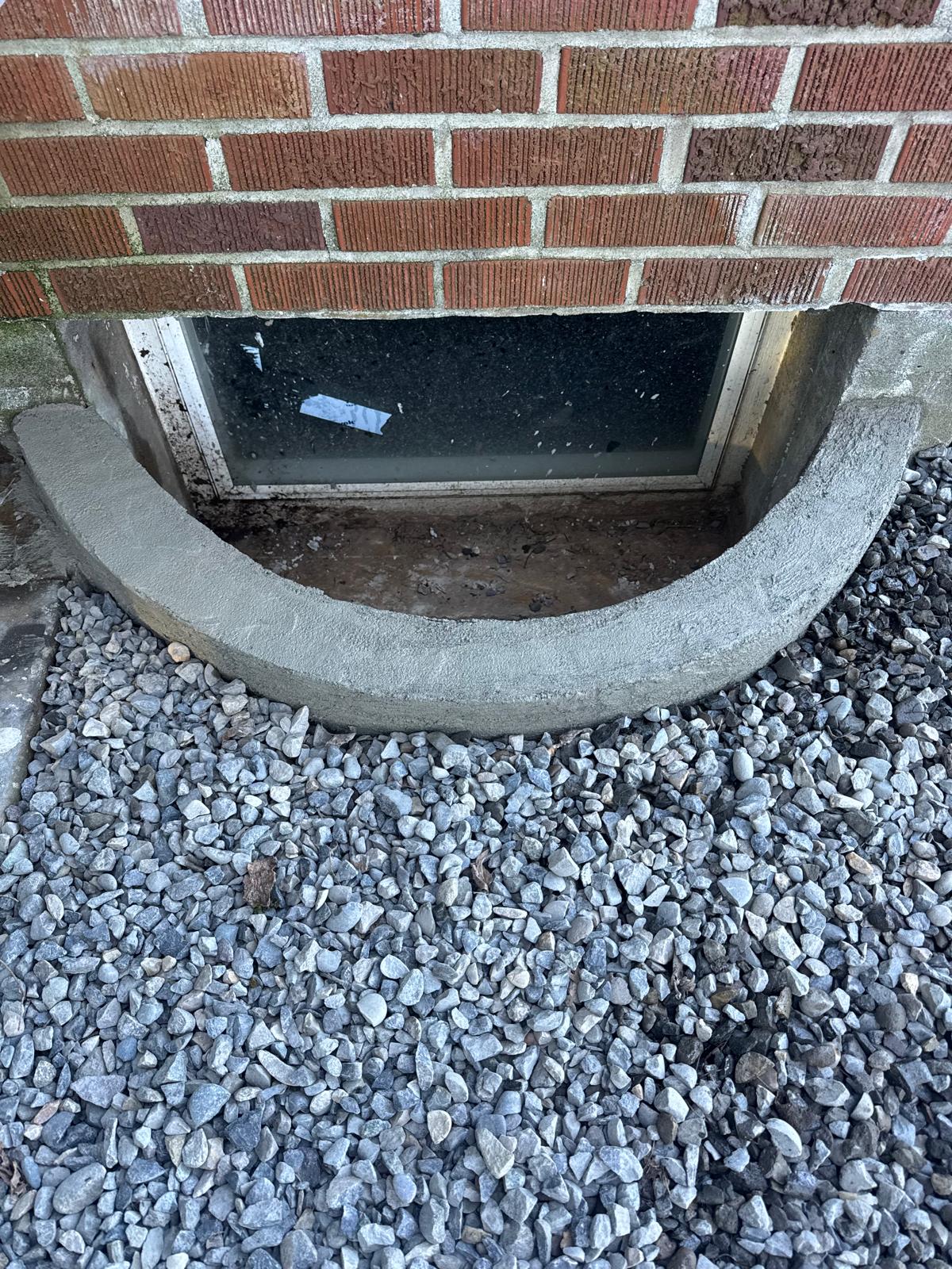 Window well with gravel surround completed by Metro Mowing Services and Maintenance LLC