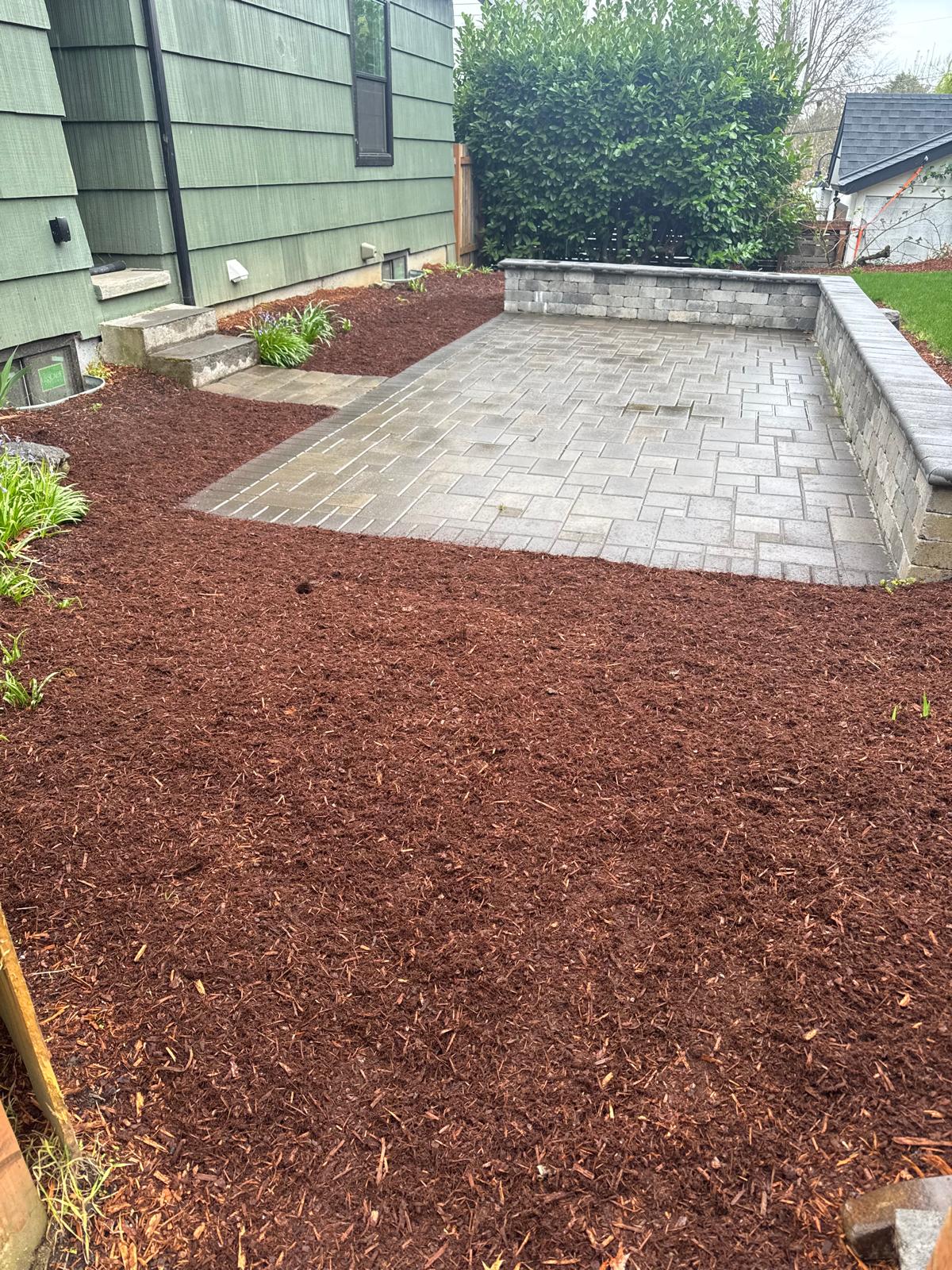 Paver patio with fresh mulch beds completed by Metro Mowing Services and Maintenance LLC