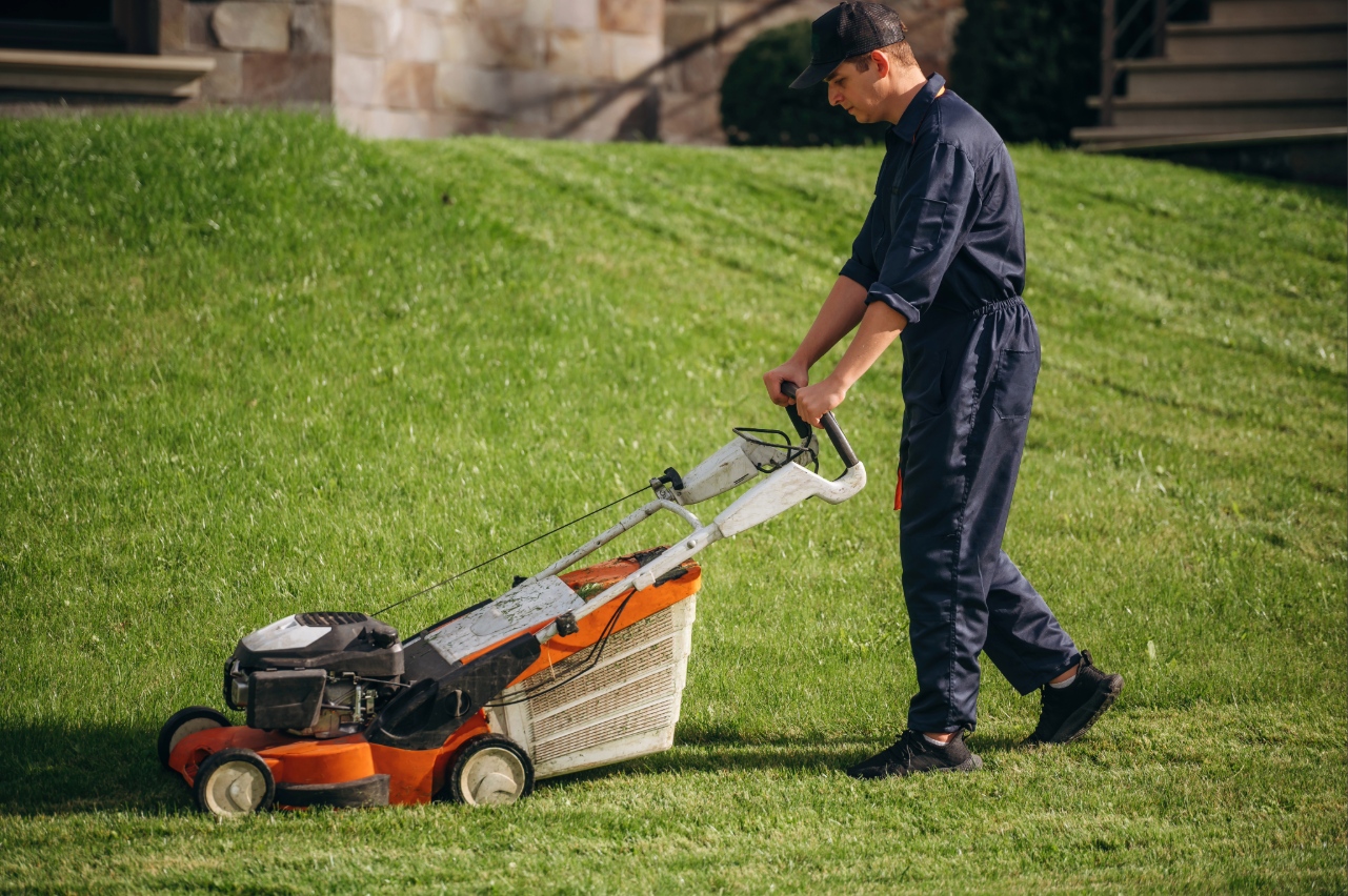 Professional mowing a residential lawn with commercial lawn mower