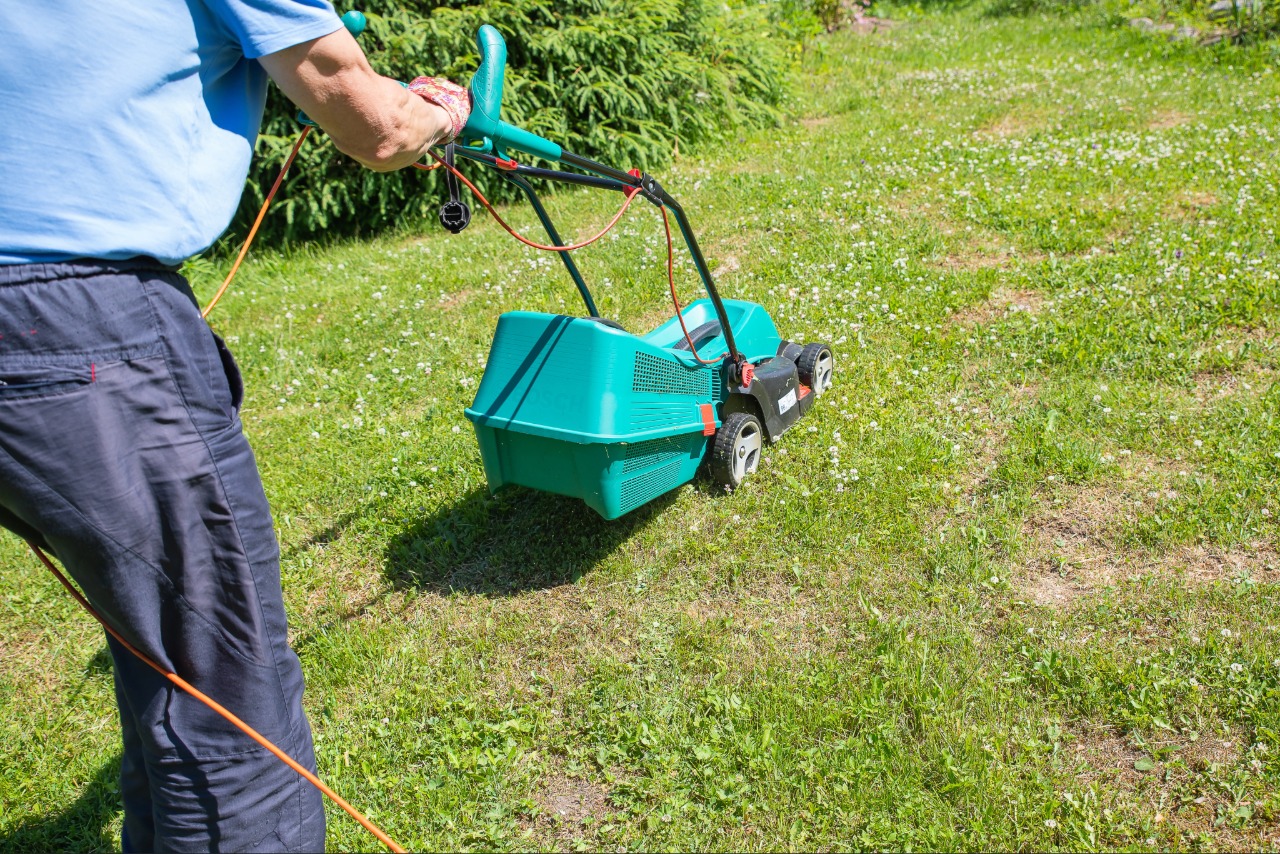 Core aeration machine improving soil health in a residential lawn