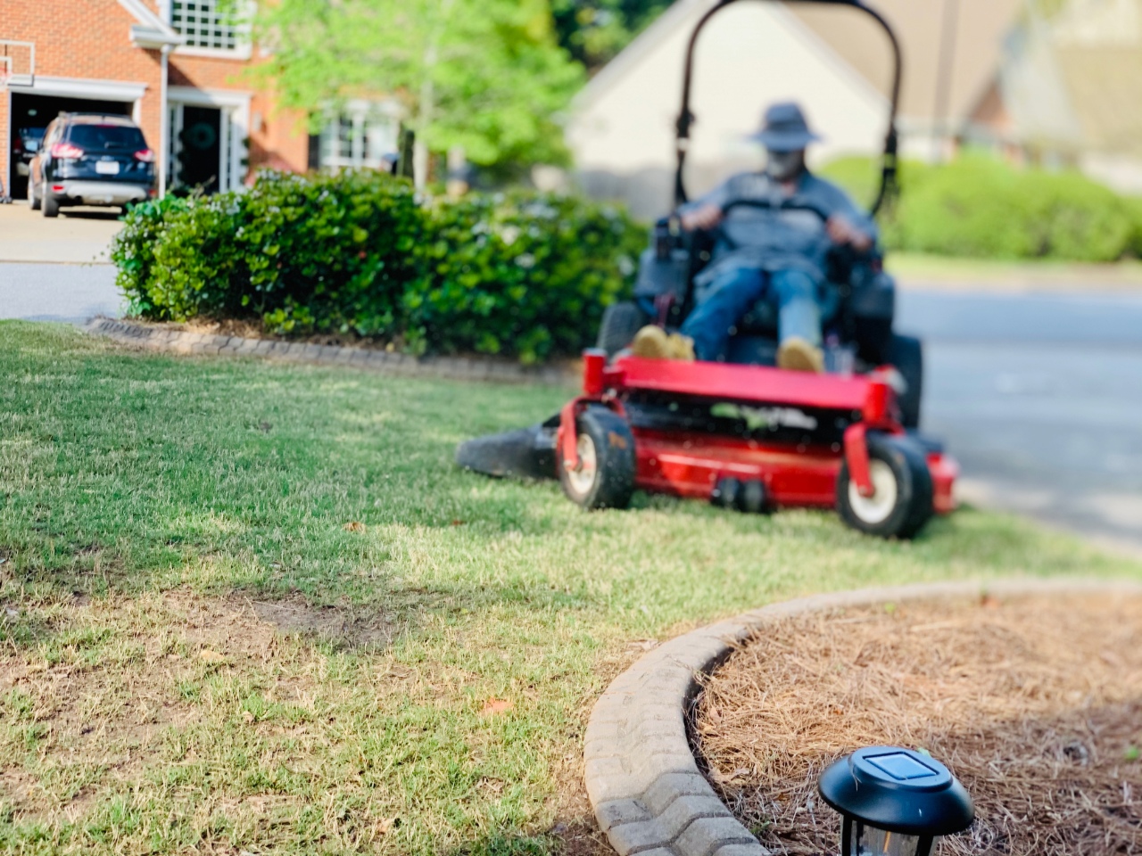 Commercial lawn mower cutting residential grass Commercial lawn mower cutting residential grass