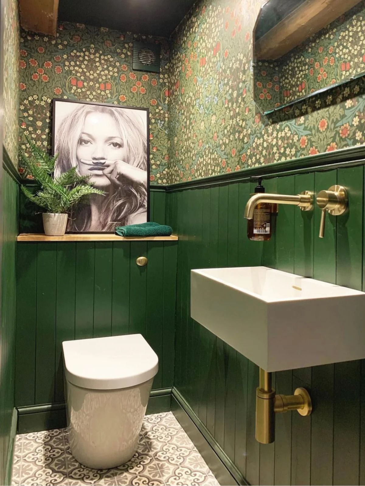 Luxury cloakroom with green panelling and patterned wallpaper