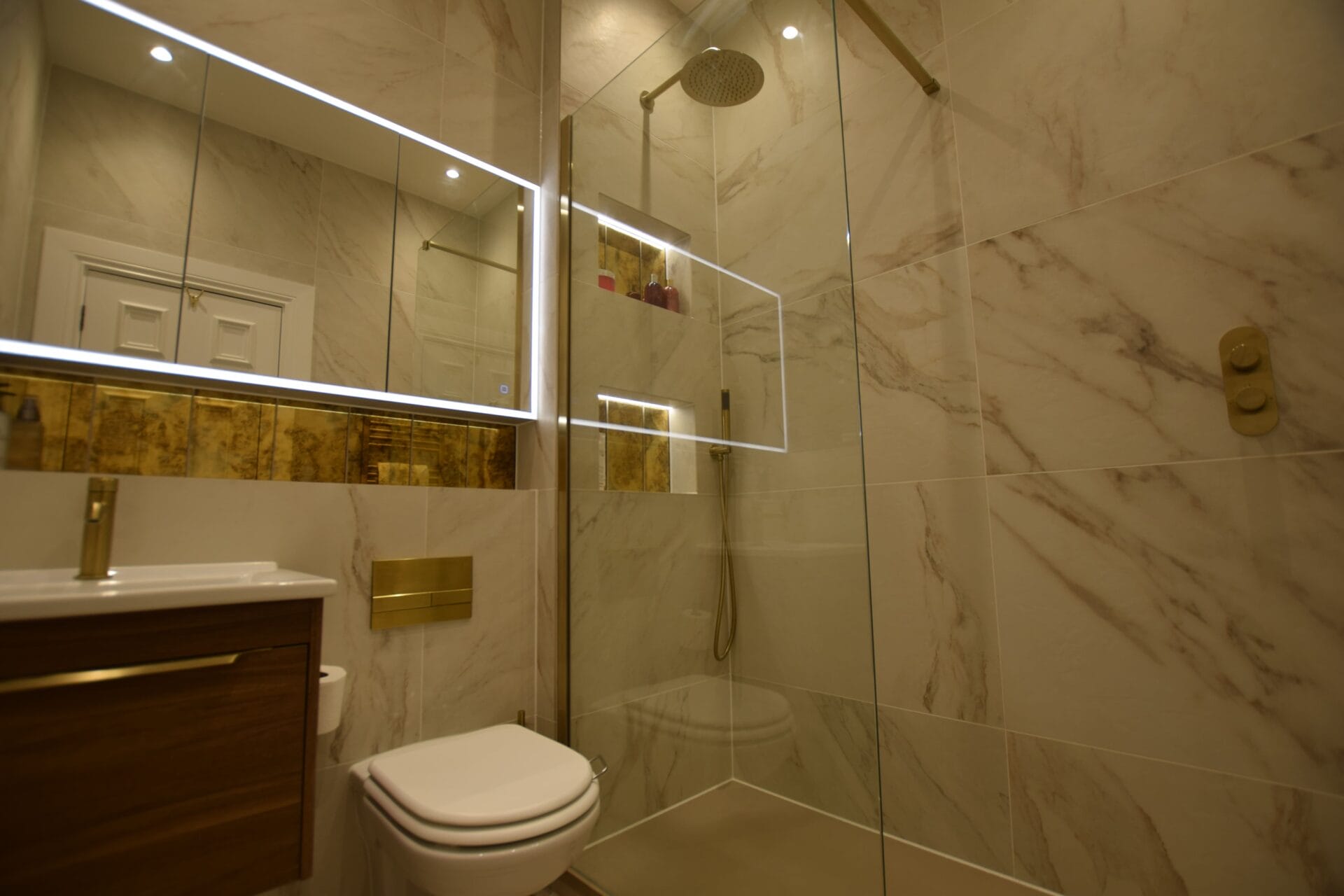 Walk in wet room shower with brushed brass fittings