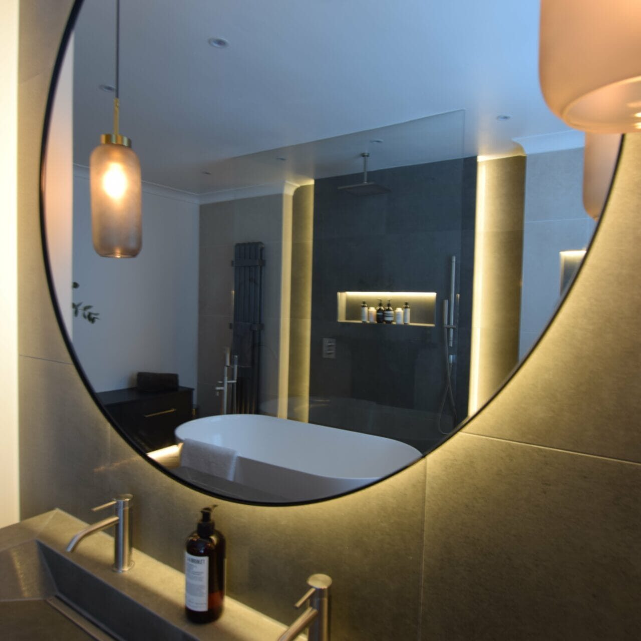 Circular illuminated mirror in Bathford wet room