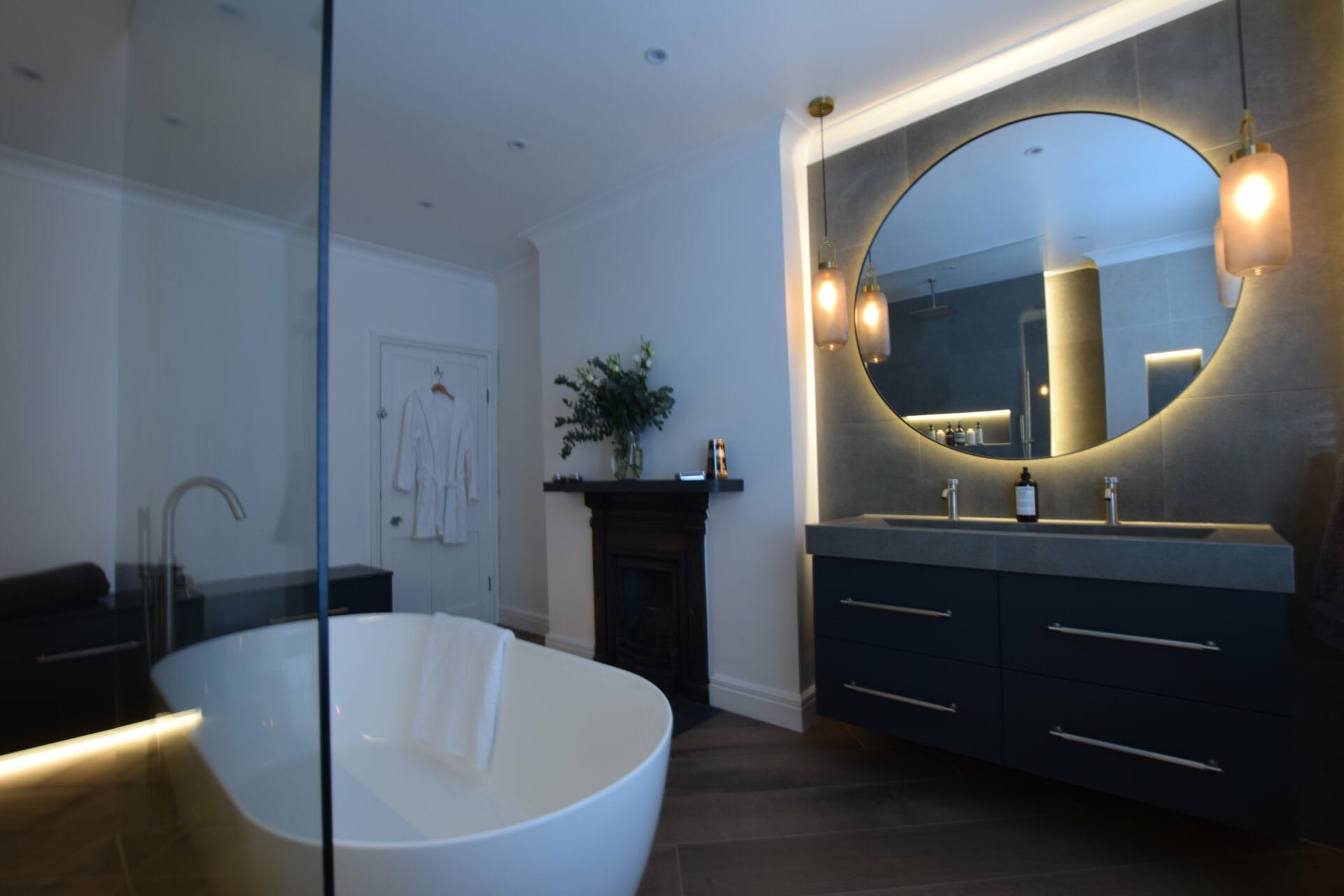 Large circular mirror and contemporary wet room interior