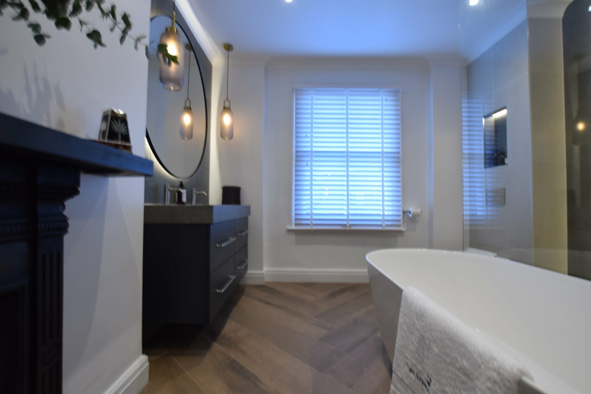 Dark vanity and feature mirror in Bathford wet room