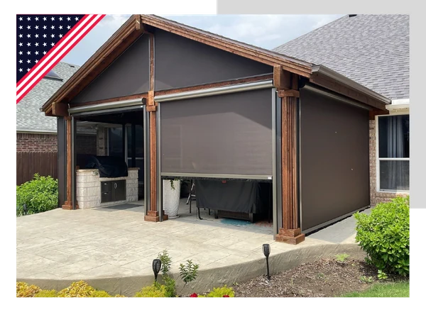 Brown motorized screens lowered on a patio structure with an American flag