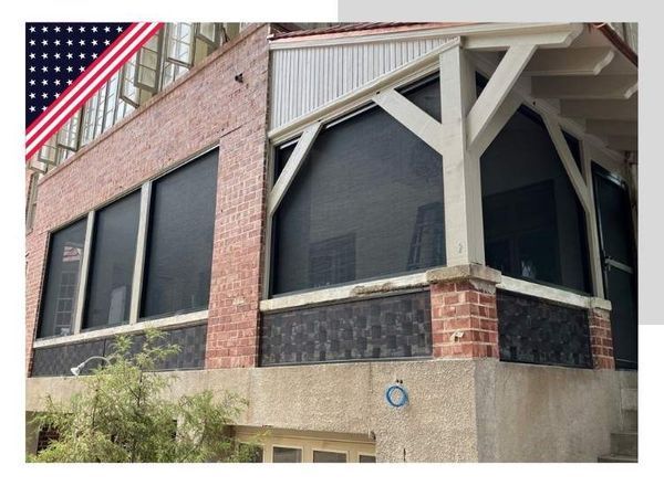 Retractable screens lowered on a two-story brick building