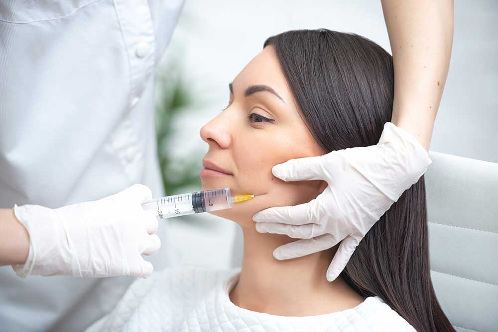 Provider preparing a Botox injection at White Pearl Medical Spa