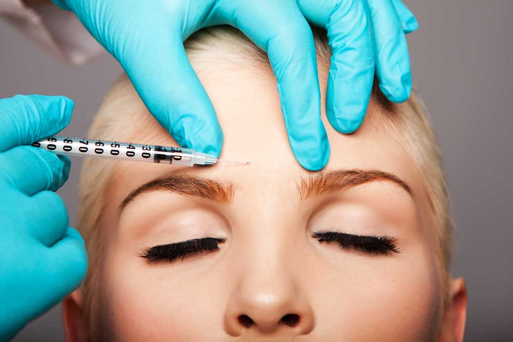 Botox provider explaining treatment during a consultation