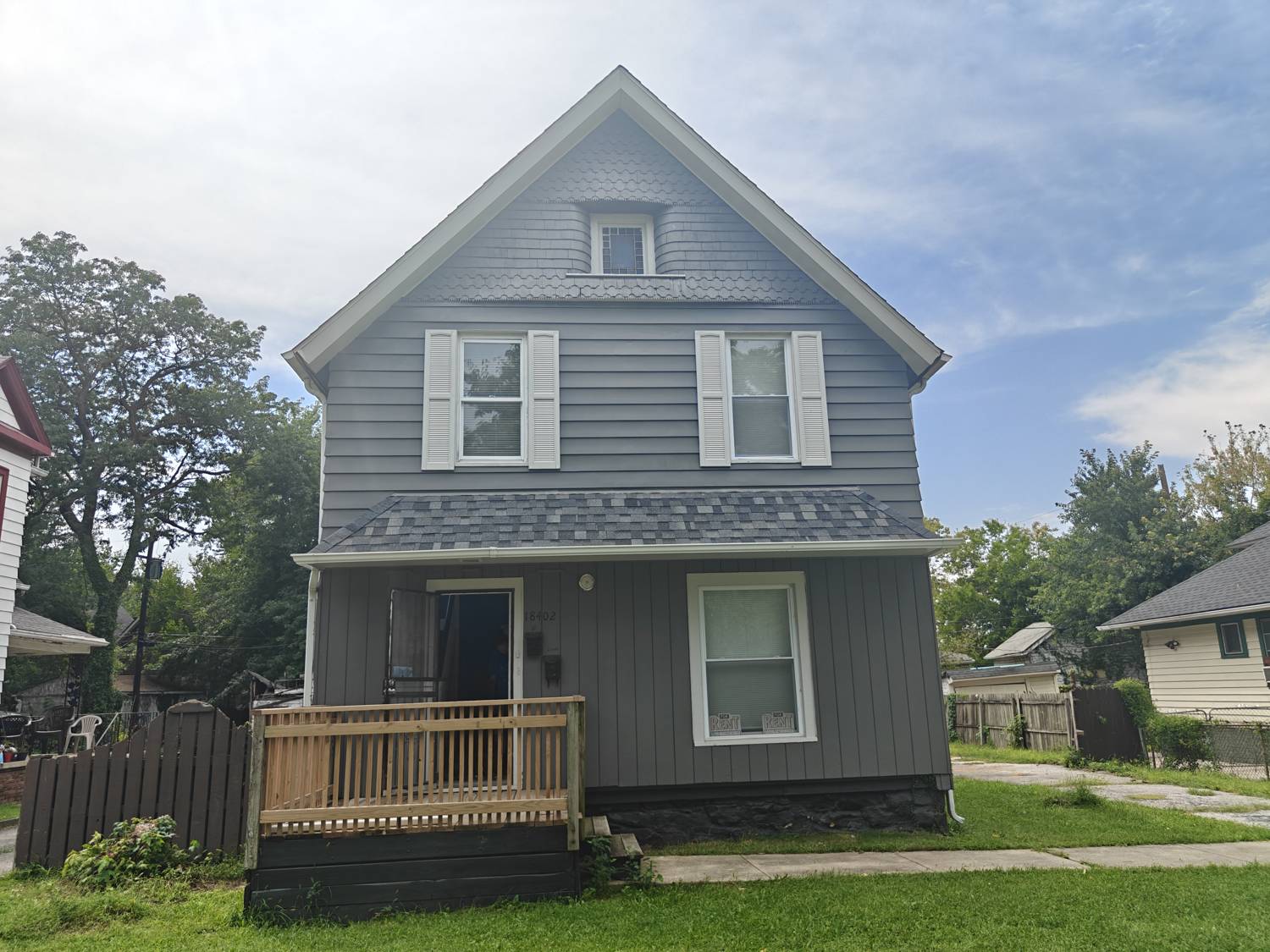 Front of 18402 Melville Rd, a two story two-family with a covered front porch