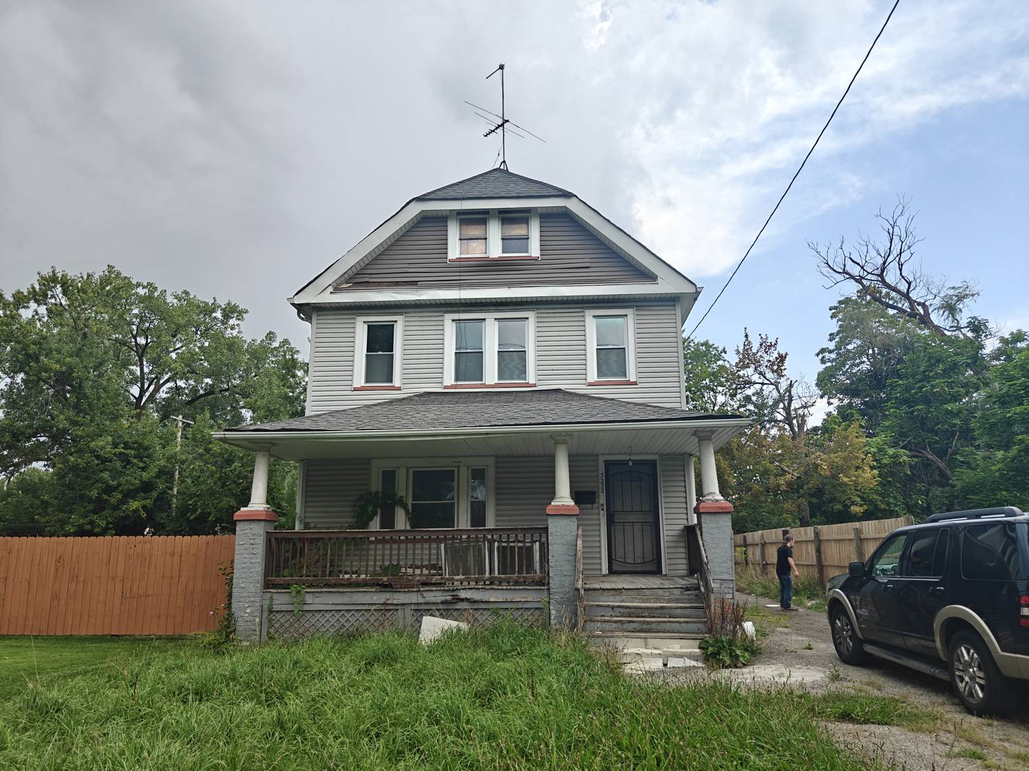 Front of 3232 E 117th St, a two story Colonial with a gambrel roof and covered front porch
