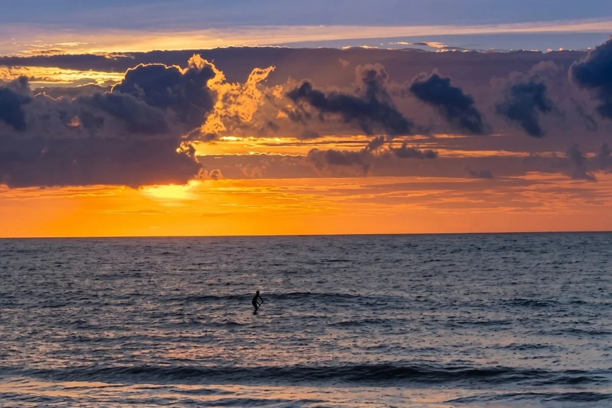 sunrise paddle boarder in neptune beach, florida