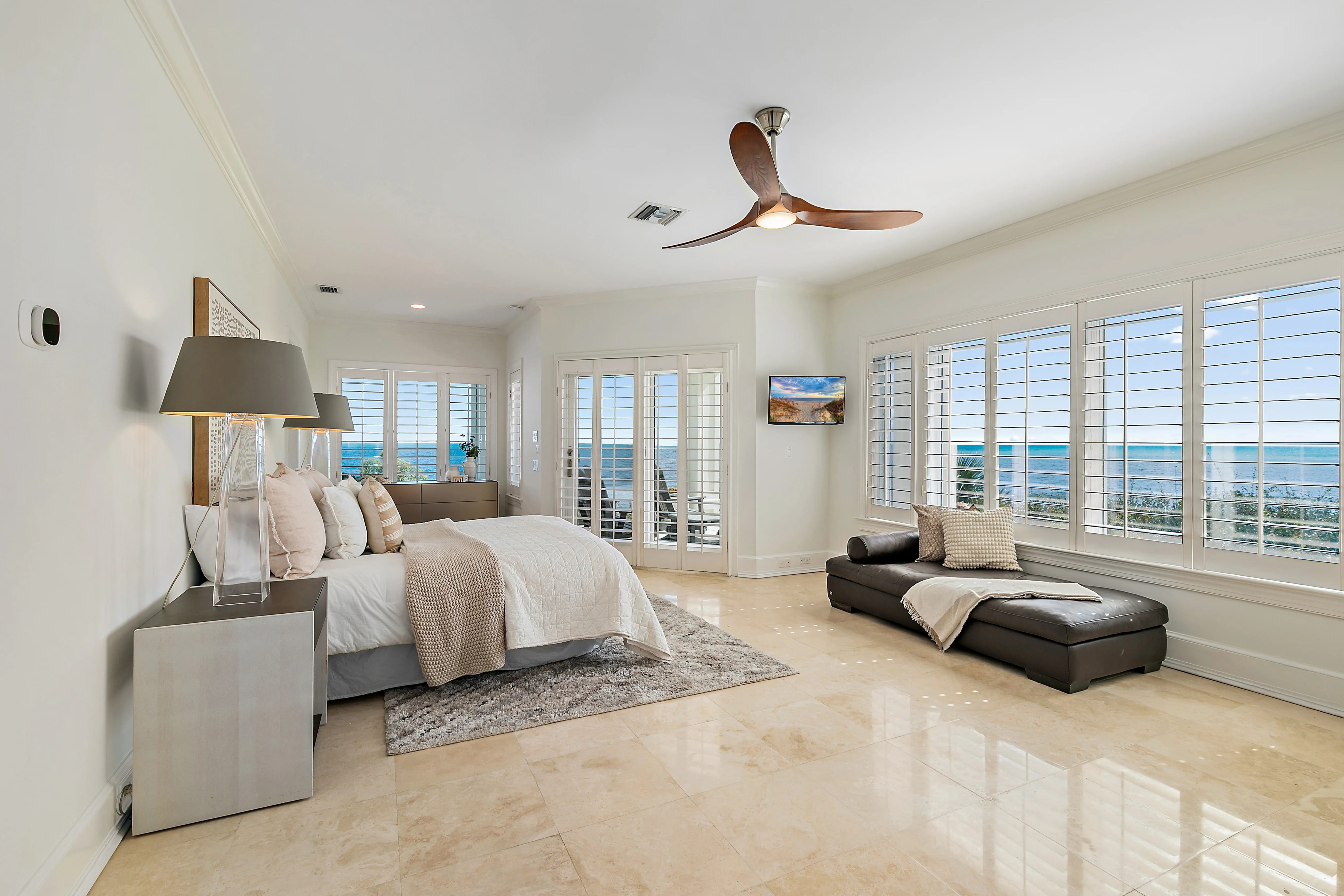 Staged primary suite with view of the ocean