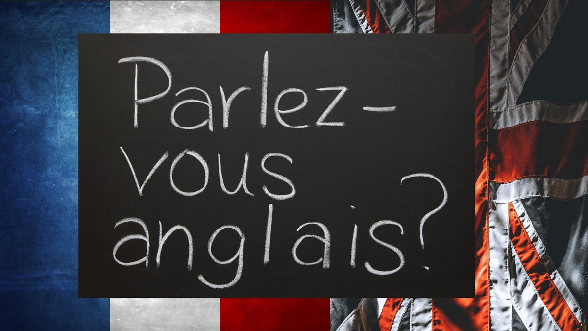Un tableau noir : « Parlez-vous anglais ? », entre les drapeaux français et britannique