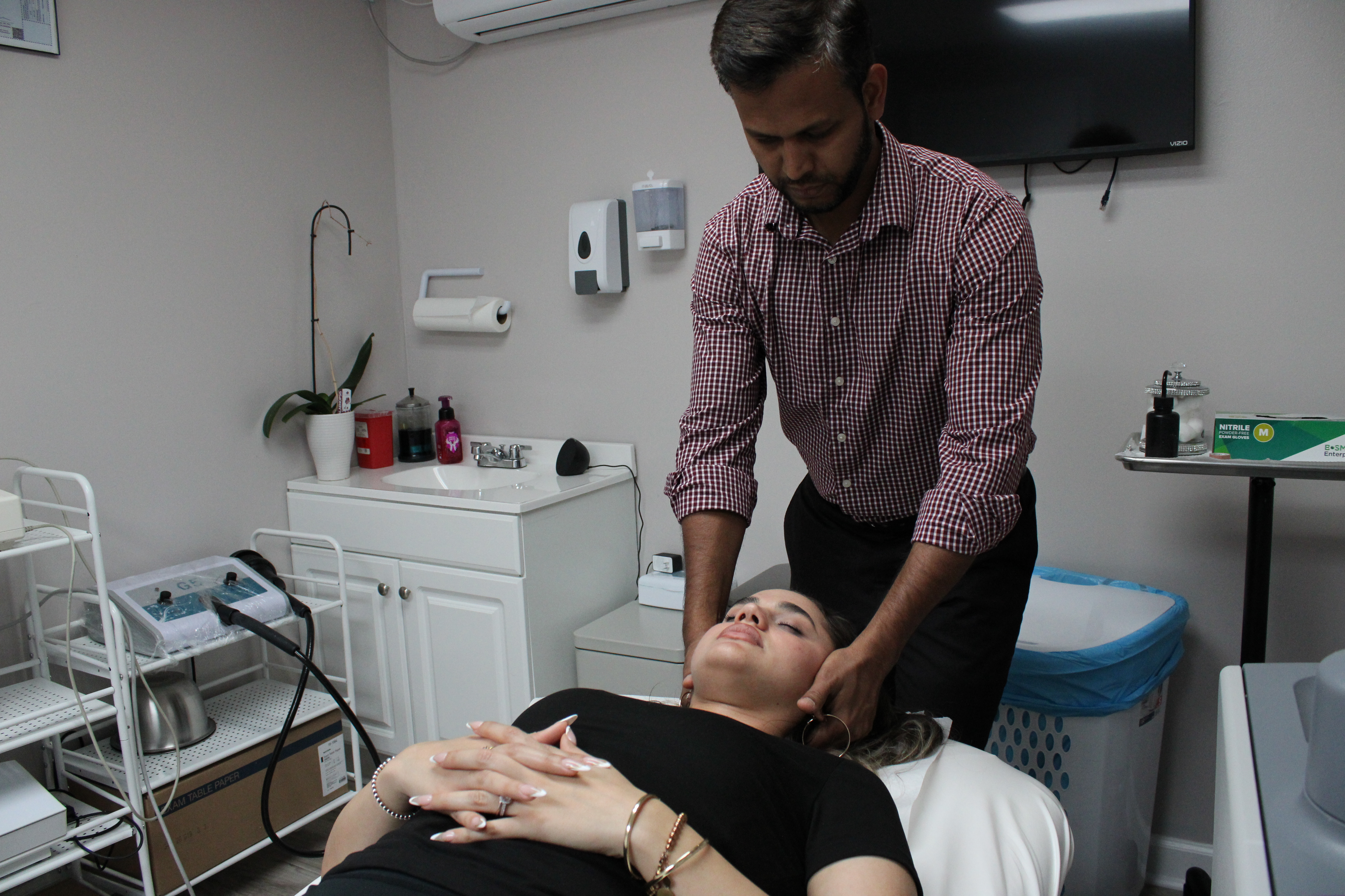 Dr. Ansari coaching a patient through a squat