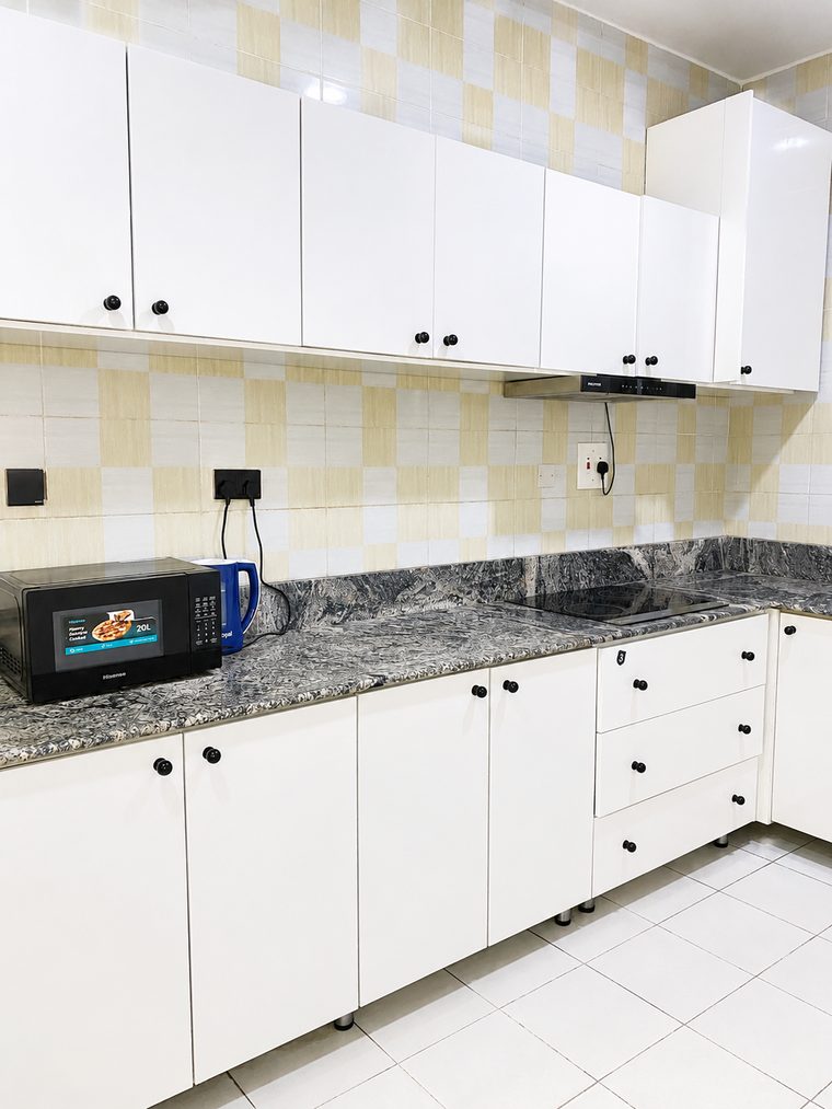 Fitted kitchen with granite worktop, hob and microwave