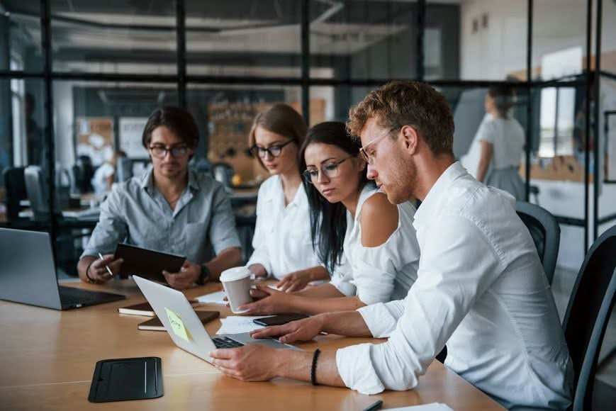 Tech professionals in formal clothes working in an office.