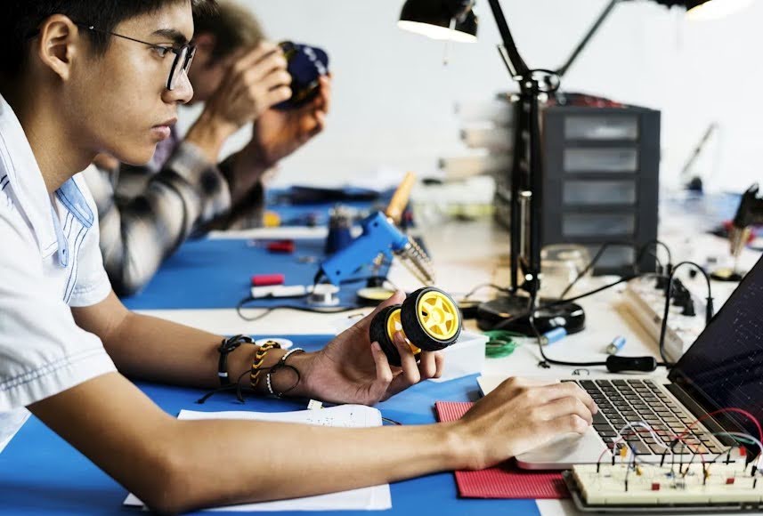 Side view of a man working on a product’s work-like prototype.