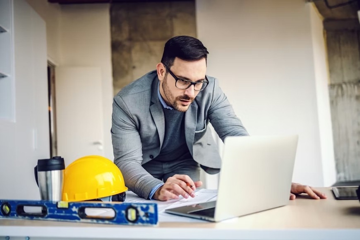 A young tech professional working on a product concept on his laptop