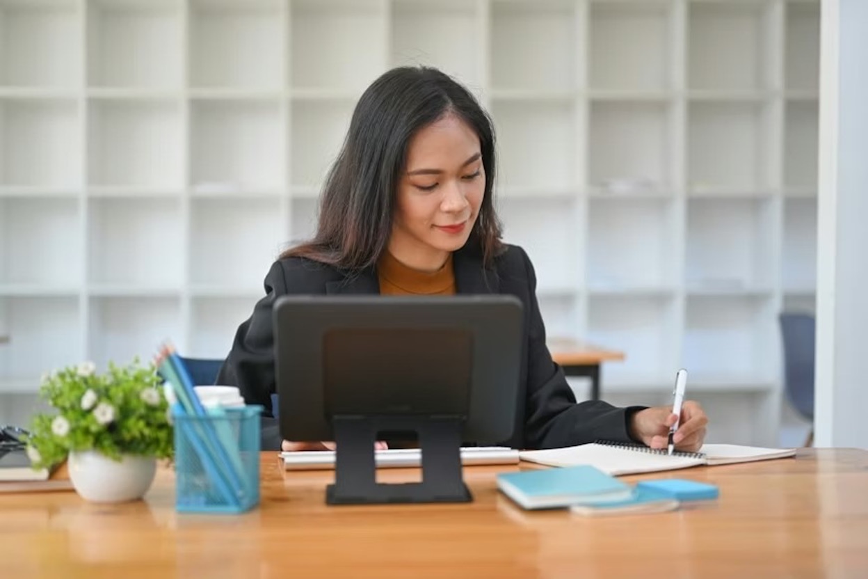 A woman working on a document in a modern office