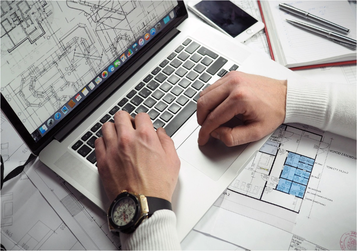 An inventor going over the blueprint of his patented design