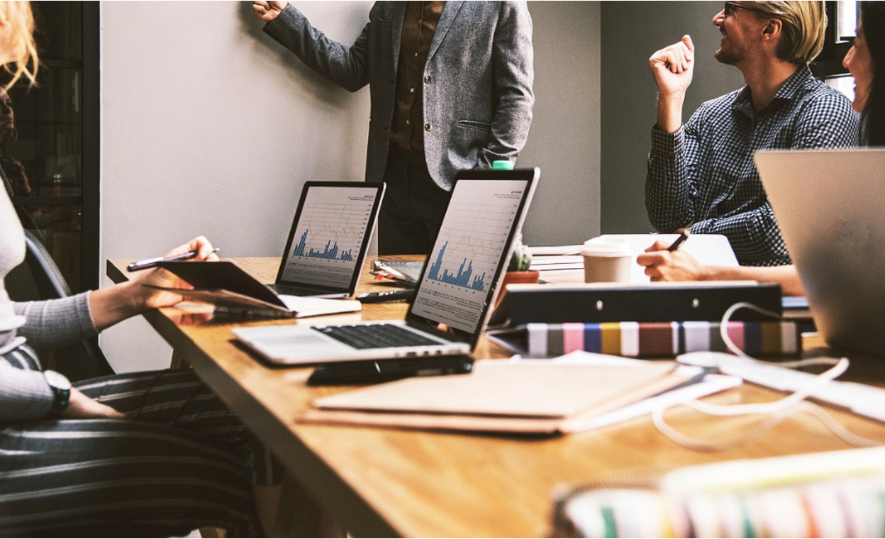 A group of inventors discussing a new product launch in an office