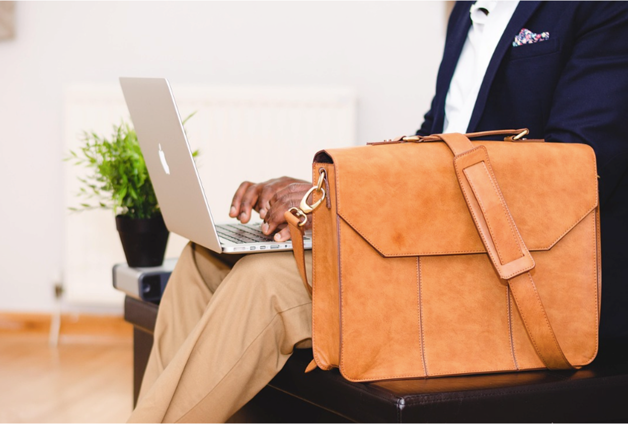 An inventor working on a patent assignment application on a computer