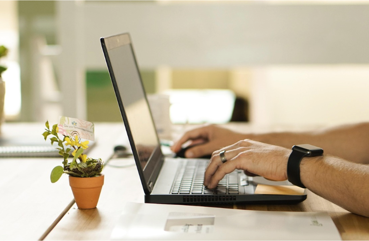 A person filing a patent claim on a computer A person filing a patent claim on a computer
