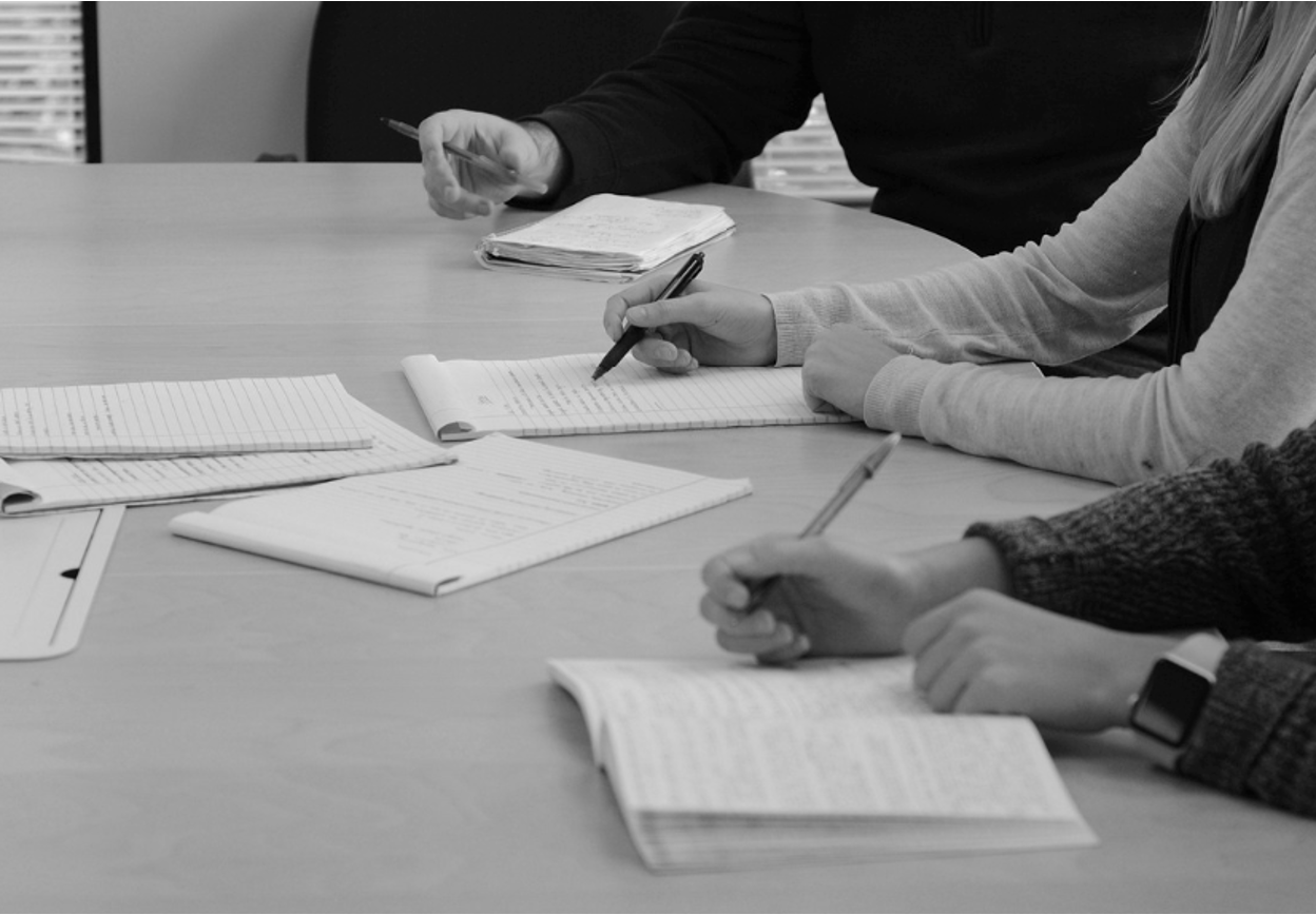 A group of business partners discussing a strategy for protecting their intellectual property