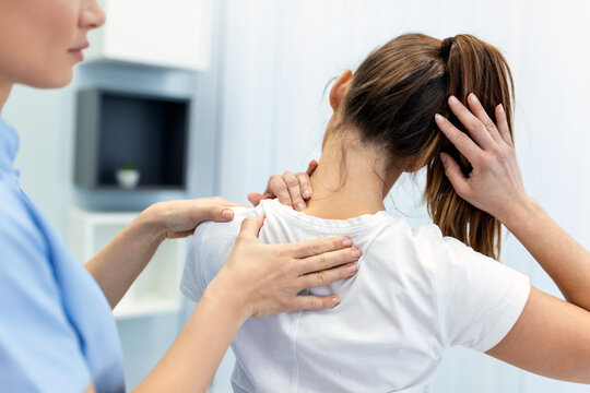 Osteopath hands on patient back adjustment