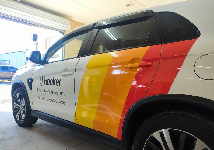 Tonz Signs & Graphics team creating custom signage and decals in Matamata