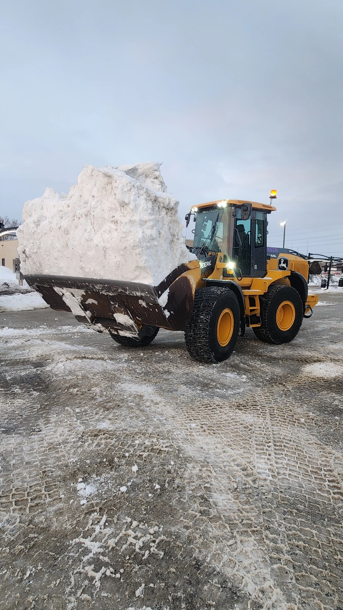 Snow removal loader filling a dump truck
