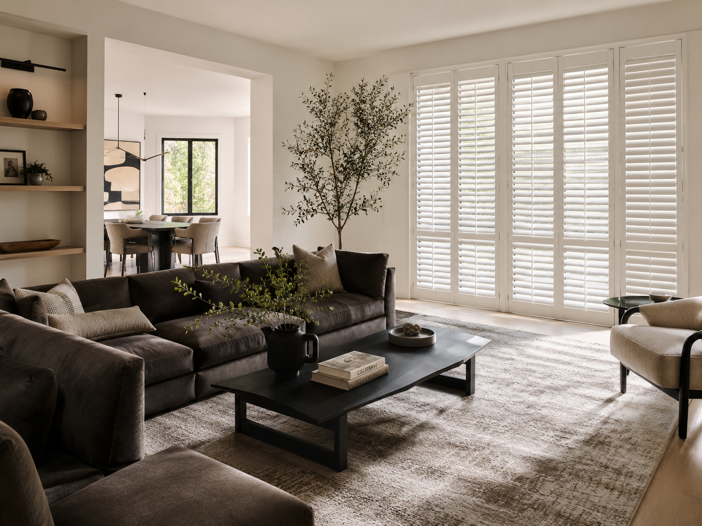 Interior plantation shutters in a living room with neutral shutter finish options