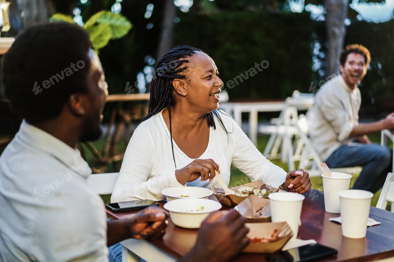 Neighbours sharing a long table at dinner