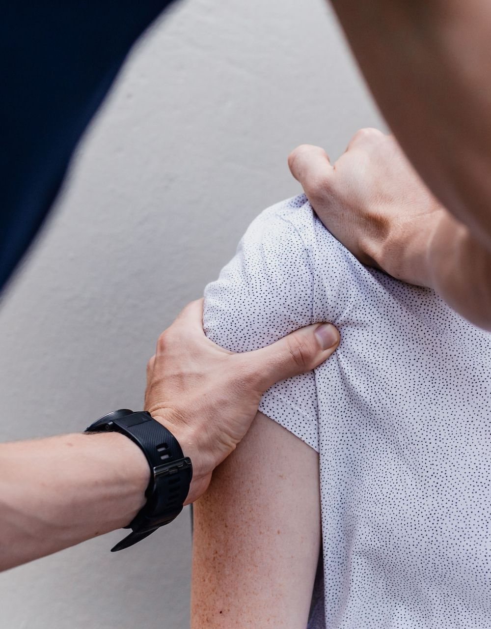 Physiotherapist treating a patient's shoulder