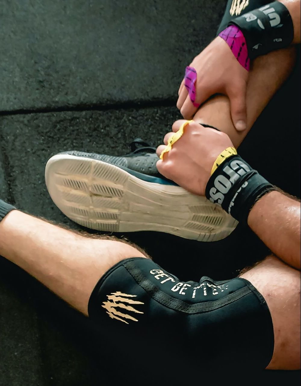 Athlete with a taped ankle and knee sleeve