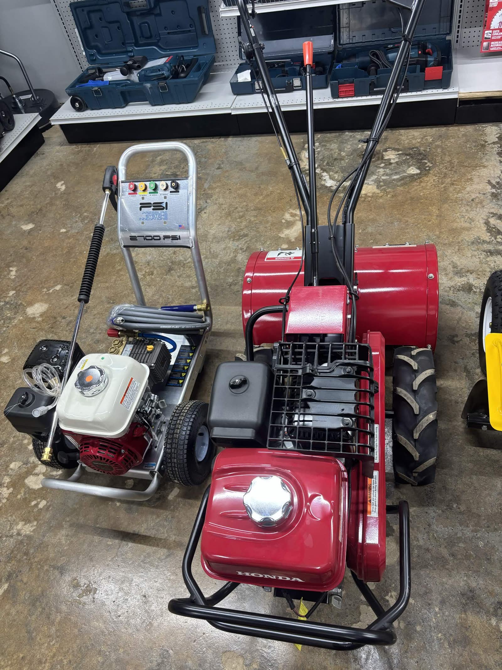 2700 PSI pressure washer and Honda red rear-tine tiller on the rental floor