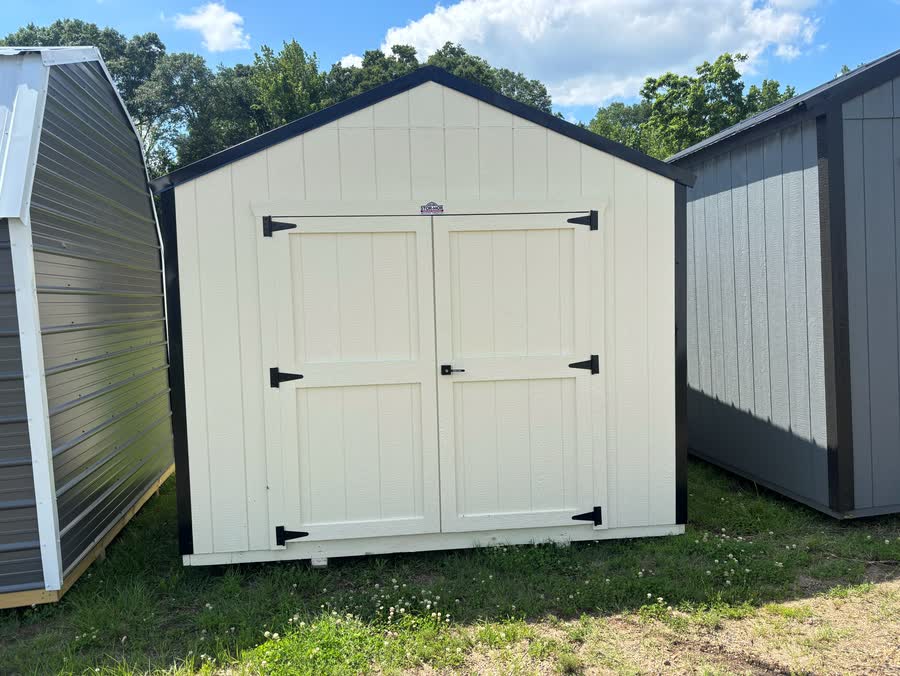 Cream Stor-Mor utility shed with black trim and double cross-buck doors at Cardinal Hardware