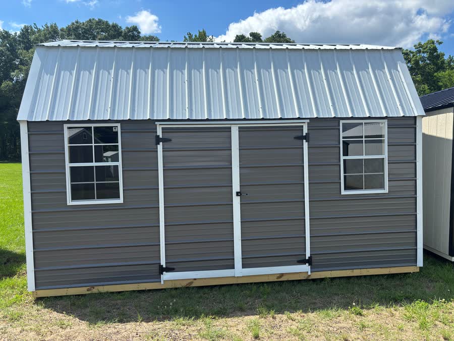 Warm-gray Stor-Mor side lofted barn with gambrel roof, double doors and two windows at Cardinal Hardware