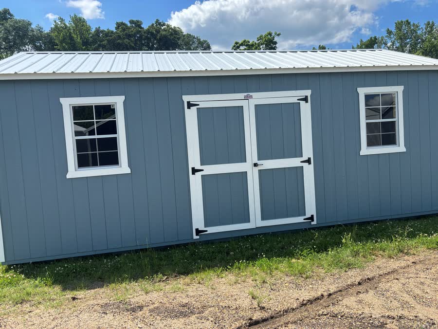 Long light-blue Stor-Mor side garden shed with white trim, centered double doors and two windows at Cardinal Hardware