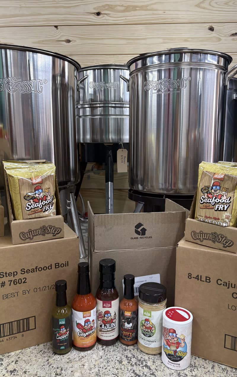 Cajun seasoning and seafood boil display with stainless boil pots