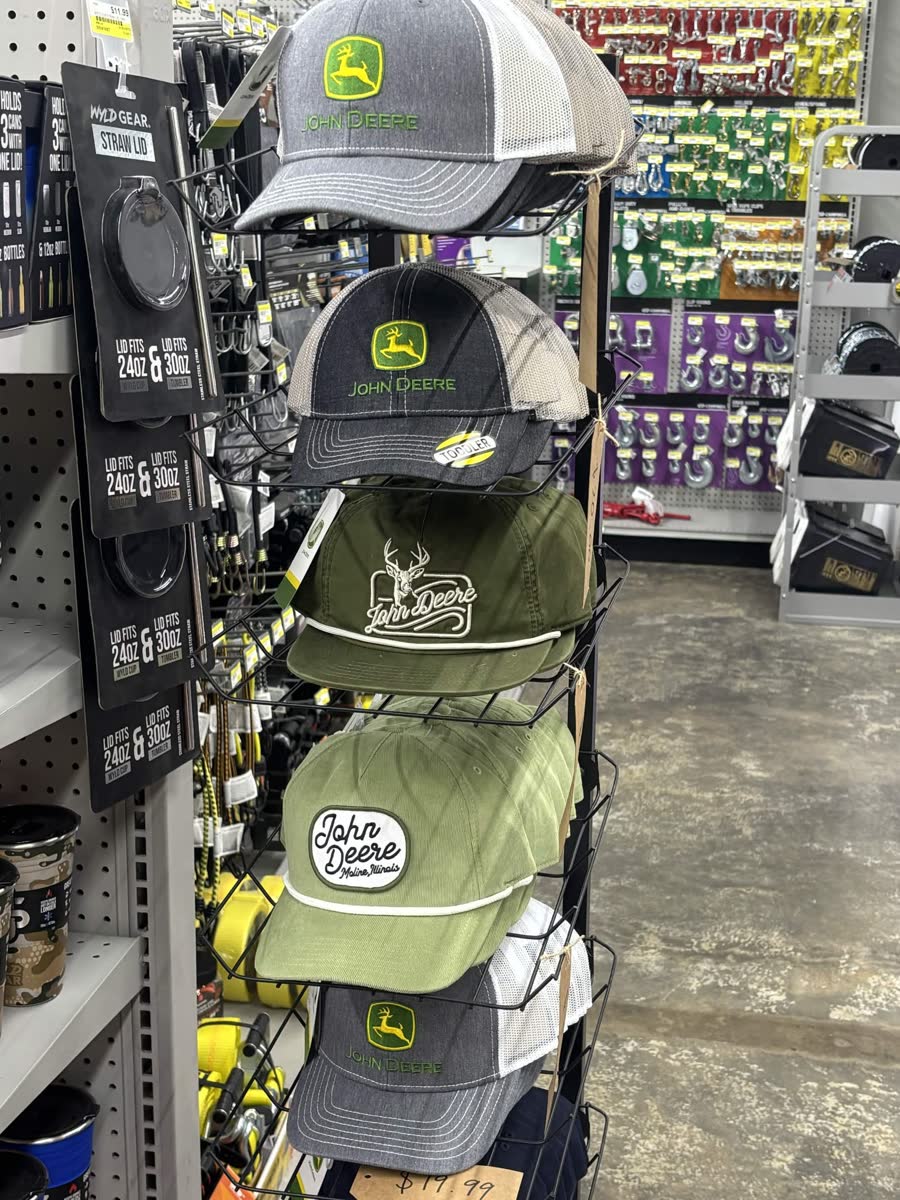 John Deere hats on display — gray, charcoal, olive with deer logo